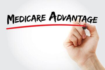 Hand writing Medicare Advantage with marker, concept background