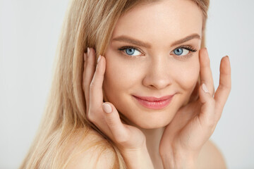 Woman Face Care. Young Female With Hands Touching Beauty Skin