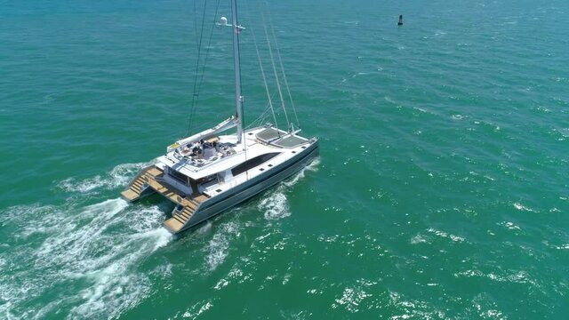 Aerial drone follow catamaran in the water 4k 60p