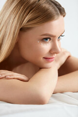 Beauty Cosmetics. Woman With Drops Of Eye Skin Cream On Skin