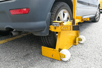Car wheel clamp on street for illegal parking