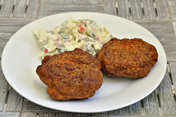 Meatballs with Potato salad / two meatballs with potato salad on white plate, close up, macro, full frame 
