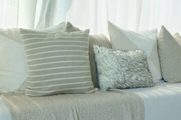 Fototapeta na wymiar Brown color scheme pillows setting on sofa in living room