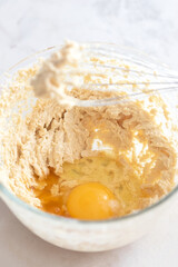 MIxing baking ingredients in a bowl for cake or pancakes. Light food photography concept