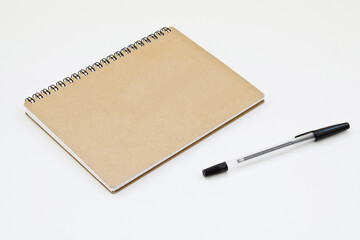 Notebook and pen on a white background