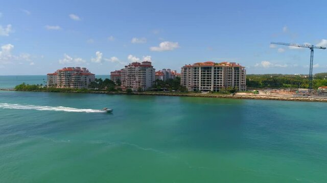 Aerial video of a boat passing by Fisher Island Miami Beach 4k 60p