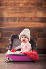 Cute baby in pink travel bag