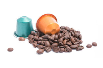 coffee capsules with coffee beans on white background