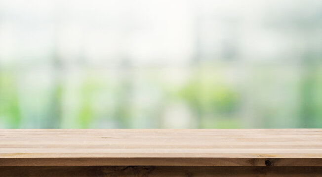 Wood table top on white abstract window glass background.For montage product display or key visual layout