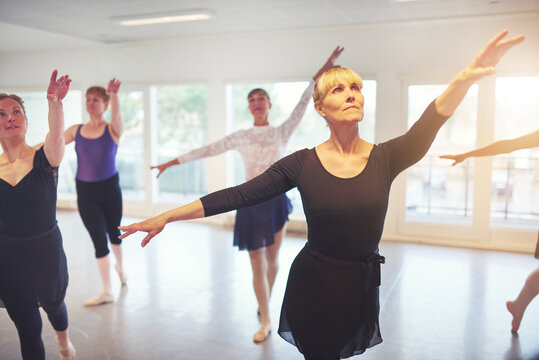 Adult women posing with hands up dancing ballet