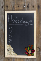 Space chalkboard background texture with wooden frame with the word "Holidays". blackboard space for wallpaper. Landscape mounting style vertical.
