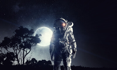 Fototapeta premium Astronaut in outer space. Mixed media