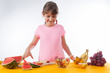 Little girl starting to eat fruit salad - healthy food concept - isolated