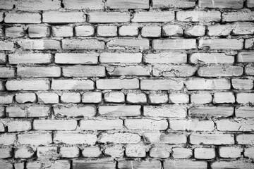 Fragment of old brick fence whitewashed by lime, relief surface and natural background, black and white effect