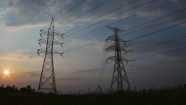 Electric pole, High voltage towers and sky sunset, day to night, Time lapse