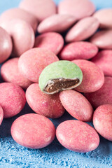 Red and green round chocolate candies on the blue wooden table