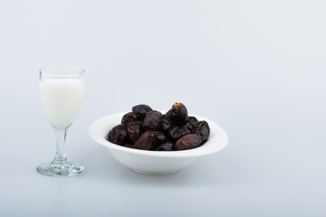 Isolated dates with milk in a plate 