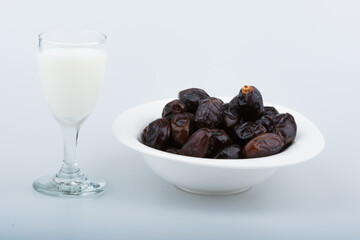 Isolated dates with milk in a plate 