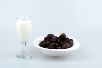 Isolated dates with milk in a plate 