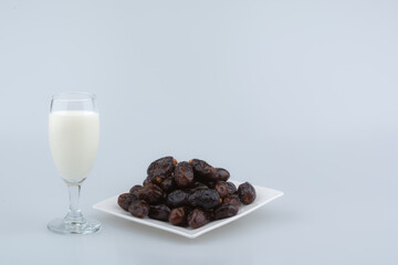 Isolated dates with milk in a plate 