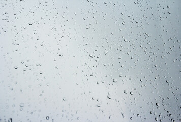 Rain drops on glass window in rainy day