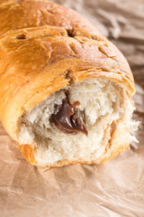 Sliced chocolate croissant on the wrinkled brown paper