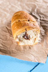 Sliced chocolate croissant on the wrinkled brown paper