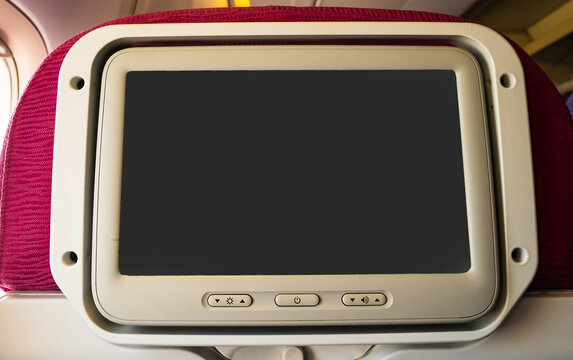 Private monitor on airplane seat to entertainmentservice for passenger in travel concept..