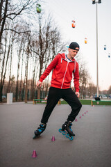 Roller skater legs in skates on asphalt walkway