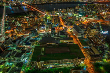 Obraz premium Aerial view of Osaka City Central business and Yodo River with its bridges at night. Osaka Skyline from Kita ward of Japan. Osaka is Japan's third largest city by population after Tokyo and Yokohama.