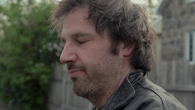 Portrait of an unshaven man looking confused.