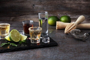Selection of alcoholic drinks on rustic stone plate