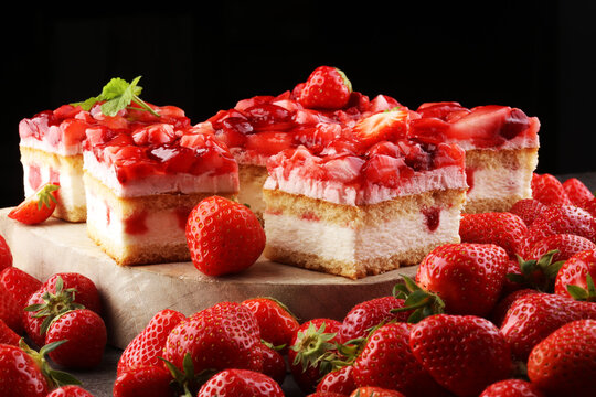 strawberry cake and many fresh strawberries on grey background