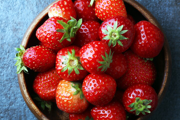 Fresh red strawberry loosely laid in different positions.