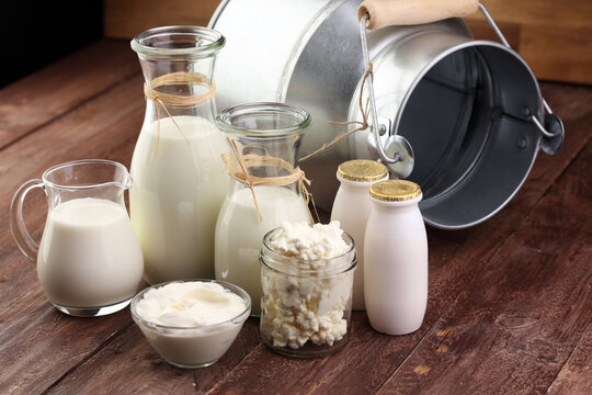 milk products - tasty healthy dairy products on a table on: sour cream in a white bowl, cottage cheese bowl, cream in a a bank and milk jar, glass bottle and in a glass