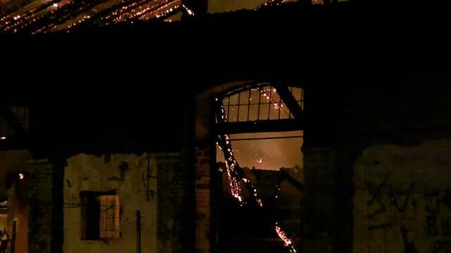 old warehouse on fire at night -  zoom out