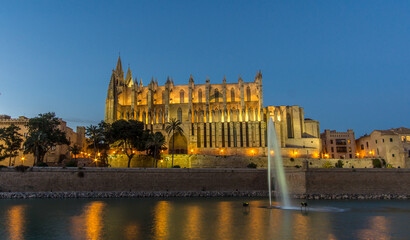 Fototapeta na wymiar Palma de Mallorca Cathedral sunset. Night lighting reflected in water. Balearic islands of Spain