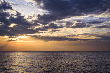 Sunset sky at sea with gold theme.