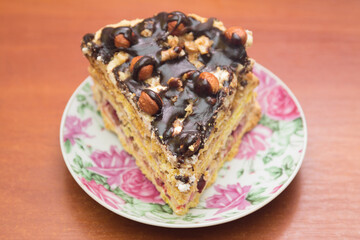 Piece of cake with hazelnuts and chocolate - in a saucer