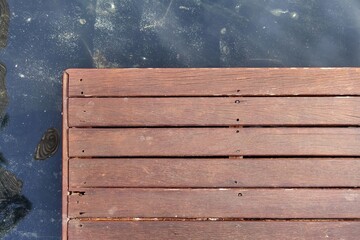 Wooden planks balcony over water pool