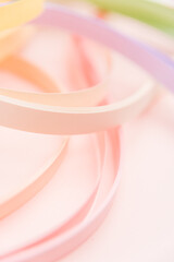 Rainbow colored filigree paper laid out in waves and shapes