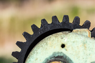 Old gears and cogs against blurred background