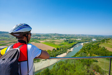 Cyclist looking at panorama from Langhe region,Italy