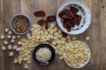 Orecchiette Pasta ingredients preparations with mixed vegetable seasoning, cheese, bay scallops, handmade