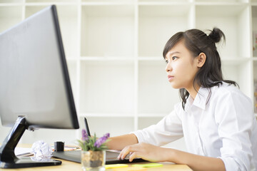 Graphic designer using graphics tablet and computer in the office