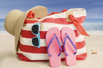Woman bag and beach item on sand