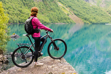 Fototapeta premium Biking in Norway against picturesque landscape