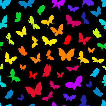 Rainbow colorful silhouettes of butterflies on black background seamless pattern