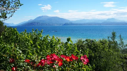 Fototapeten Amazing view of Lake Garda from the hills of the park Parco Pubblico Tomelleri in Sirmione town, Italy  © zigres