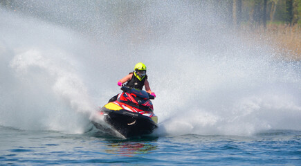  Jet Ski  racer cornering at speed creating at lot of spray.